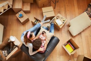 Millennial Parents moving to a new flat. Lifestyle shot in real location, Spain.